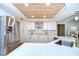 Modern kitchen with stainless steel appliances, white cabinets, and quartz countertops at 17302 Stetson Ln, Odessa, FL 33556