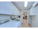Modern laundry area with sleek cabinets, stone backsplash, and convenient washer/dryer at 17302 Stetson Ln, Odessa, FL 33556