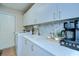 Laundry room with granite countertop, cabinets, sink, coffee station, washer, and dryer at 17302 Stetson Ln, Odessa, FL 33556