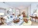 Bright and airy living room featuring a comfortable seating arrangement and views of the dining area at 17302 Stetson Ln, Odessa, FL 33556