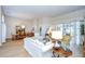 Spacious living room with dining area, wood floors, and sliding glass doors to pool at 17302 Stetson Ln, Odessa, FL 33556