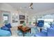 Cozy living room featuring a stone fireplace, built-in shelves, and a comfortable seating arrangement at 17302 Stetson Ln, Odessa, FL 33556