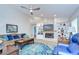 Inviting living room with a stone fireplace, built-in shelving, and a comfortable seating area at 17302 Stetson Ln, Odessa, FL 33556