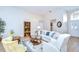 Bright living room with natural light, features cozy seating, and wood-style flooring at 17302 Stetson Ln, Odessa, FL 33556