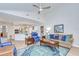 Open-concept living room featuring a comfortable seating area, a vibrant rug, and seamless flow to the kitchen at 17302 Stetson Ln, Odessa, FL 33556