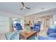 Open concept living room with sliding glass doors, comfortable seating, and a view of the pool area at 17302 Stetson Ln, Odessa, FL 33556