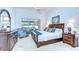 Serene main bedroom features a vaulted ceiling, plush carpet, and a private patio entrance at 17302 Stetson Ln, Odessa, FL 33556