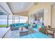 Comfortable screened patio with plush seating, a ceiling fan, and stylish outdoor furniture at 17302 Stetson Ln, Odessa, FL 33556