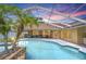 Relaxing screened pool and patio with ample outdoor seating options and gorgeous tropical views at 17302 Stetson Ln, Odessa, FL 33556