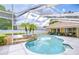 A screened-in pool area features a large pool surrounded by tropical landscaping and outdoor seating at 17302 Stetson Ln, Odessa, FL 33556