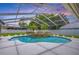 Stunning screened pool with integrated spa, mature landscaping, and ample room for entertaining at 17302 Stetson Ln, Odessa, FL 33556