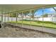 Spacious screened patio overlooking lush backyard with white fence at 1734 Mapleleaf Blvd, Oldsmar, FL 34677