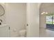 A charming half-bathroom with modern sink fixture adjacent to the back patio entrance at 1734 Mapleleaf Blvd, Oldsmar, FL 34677