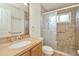 Bathroom with shower, tile surround, safety bars, and a vanity with sink at 1734 Mapleleaf Blvd, Oldsmar, FL 34677