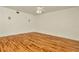 Spacious bedroom with hardwood floors, neutral paint, and a ceiling fan at 1734 Mapleleaf Blvd, Oldsmar, FL 34677
