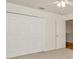Carpeted bedroom features a ceiling fan, closet, and adjoining door at 1734 Mapleleaf Blvd, Oldsmar, FL 34677