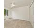 Carpeted bedroom features a ceiling fan and closet at 1734 Mapleleaf Blvd, Oldsmar, FL 34677