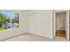 Well-lit bedroom featuring carpet flooring and a closet with bi-fold doors at 1734 Mapleleaf Blvd, Oldsmar, FL 34677
