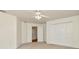 Carpeted bedroom features a ceiling fan and closet at 1734 Mapleleaf Blvd, Oldsmar, FL 34677