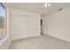 A bright, carpeted bedroom featuring a ceiling fan, closet, and natural light at 1734 Mapleleaf Blvd, Oldsmar, FL 34677