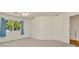 Carpeted bedroom features a ceiling fan and a window with blue curtains at 1734 Mapleleaf Blvd, Oldsmar, FL 34677