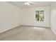Carpeted bedroom features a ceiling fan and a bright window at 1734 Mapleleaf Blvd, Oldsmar, FL 34677
