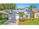 Beautiful two-story home with a well-maintained lawn and mature landscaping at 1734 Mapleleaf Blvd, Oldsmar, FL 34677