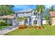 Charming two-story home with a well-manicured lawn and lovely landscaping at 1734 Mapleleaf Blvd, Oldsmar, FL 34677