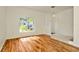 Bright foyer with hardwood flooring, a tiled entryway, and a view of the landscaped yard at 1734 Mapleleaf Blvd, Oldsmar, FL 34677