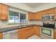 Bright kitchen features tile backsplash, stainless steel appliances, and natural light at 1734 Mapleleaf Blvd, Oldsmar, FL 34677
