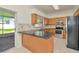Well-lit kitchen has stainless steel appliances and backyard access at 1734 Mapleleaf Blvd, Oldsmar, FL 34677