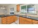 This kitchen features stainless steel appliances, a dishwasher, and granite countertops at 1734 Mapleleaf Blvd, Oldsmar, FL 34677