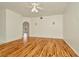 Bright living room features gleaming hardwood floors and a classic ceiling fan at 1734 Mapleleaf Blvd, Oldsmar, FL 34677