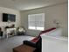 Bright bonus room that features neutral walls and grey carpeting and includes a window with white blinds at 17807 Canopy Pl, Bradenton, FL 34211