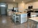 Spacious kitchen featuring an island with a sink, granite countertops, and stainless steel appliances at 17807 Canopy Pl, Bradenton, FL 34211