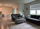 Inviting living room with tile floors, plush sofas, and ample natural light creating a comfortable ambiance at 17807 Canopy Pl, Bradenton, FL 34211