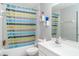 Bathroom with tub, shower, toilet and sink has updated neutral decor and a bright space at 1827 Peaceful Palm St, Ruskin, FL 33570