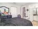 Bedroom featuring carpet flooring, a large bed, and access to a bathroom at 1827 Peaceful Palm St, Ruskin, FL 33570