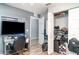 Bedroom with gray walls, wood-look flooring, desk area and closet at 1827 Peaceful Palm St, Ruskin, FL 33570