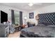 Comfortable bedroom with a large window and a dark colored bed at 1827 Peaceful Palm St, Ruskin, FL 33570