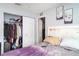 Bedroom with closet and white headboard that features floral art and neutral color scheme at 1827 Peaceful Palm St, Ruskin, FL 33570