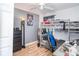This bedroom features a bunk bed with desk area, stylish floor lamp, and wood-look floors at 1827 Peaceful Palm St, Ruskin, FL 33570
