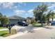 View of the front of a well-maintained house with a driveway and lawn in a residential neighborhood at 1827 Peaceful Palm St, Ruskin, FL 33570