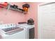 Laundry room features modern washer and dryer and a shelf at 1827 Peaceful Palm St, Ruskin, FL 33570
