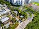 An aerial shot showcasing the property and its lush surroundings, near tennis courts and greenery at 19109 2Nd St, Indian Shores, FL 33785