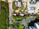 Aerial shot of the property with marked boundary lines surrounded by tropical foliage and parking areas at 19109 2Nd St, Indian Shores, FL 33785