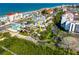 A beautiful aerial view of a property with beach access surrounded by tropical lush greenery at 19109 2Nd St, Indian Shores, FL 33785