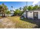Lawn featuring shed with mature trees and shrubs at 19109 2Nd St, Indian Shores, FL 33785