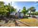 Grassy backyard with shed surrounded by mature trees at 19109 2Nd St, Indian Shores, FL 33785