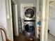 Laundry area featuring a stacked washer and dryer, and built-in shelving at 19109 2Nd St, Indian Shores, FL 33785